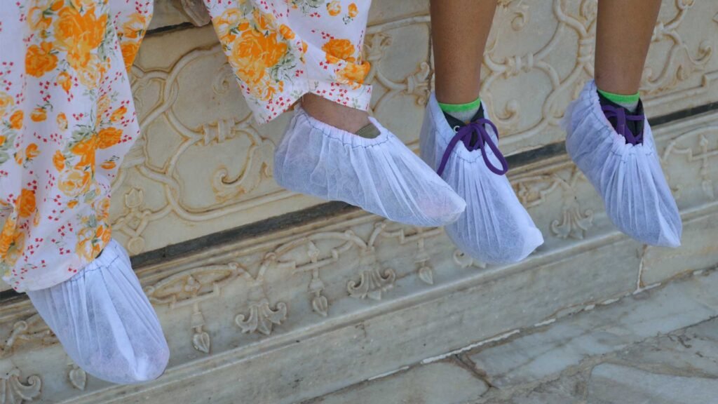 Using shower cap as shoe cover.